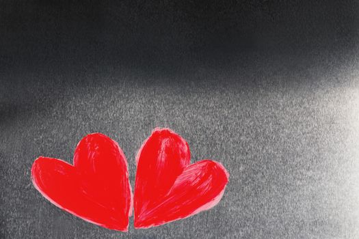 Two abstract red painted hearts on metal background