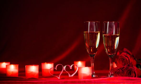 Valentines day background with champagne glasses candles and hearts