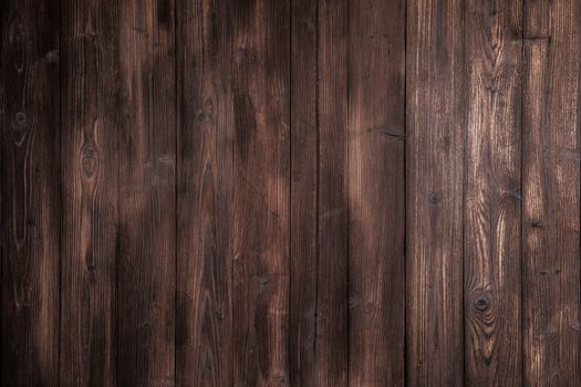 Dark brown wooden tiles floor texture background with dramatic light
