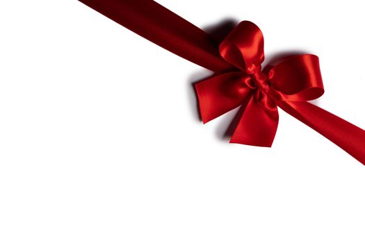 Red satin ribbon bow isolated on white background