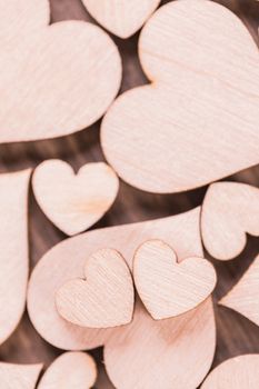 Many wooden colorless hearts background, two special ones true love concept