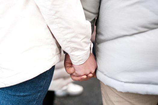 A couple in love holding hands. Closeup