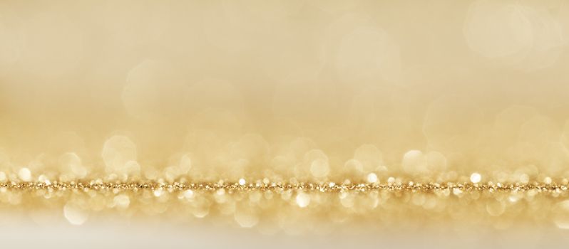 Shiny golden bokeh glitter lights abstract background, Christmas New Year party celebration concept