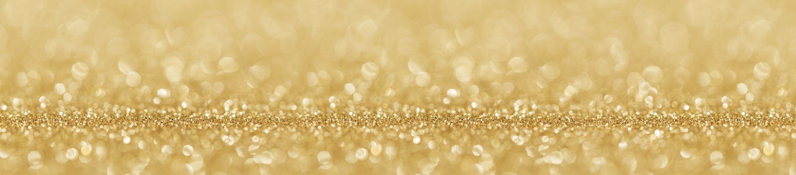Shiny golden bokeh glitter lights abstract background, Christmas New Year party celebration concept