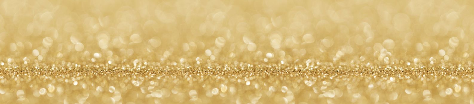 Shiny golden bokeh glitter lights abstract background, Christmas New Year party celebration concept