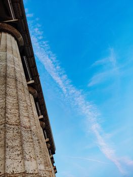 Columns on blue sky background. Vertical photo