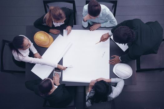 Top view of people around table in construction business meeting