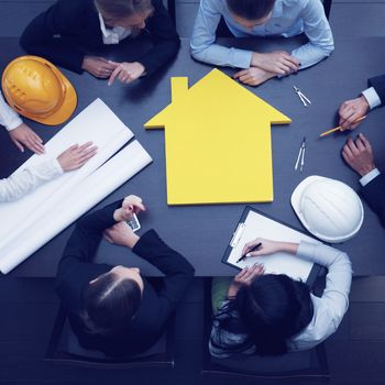 Top view of people around table in construction business meeting