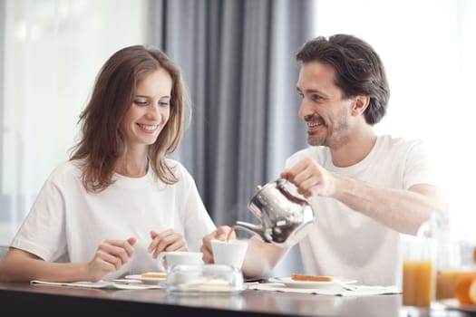 Couple having breakfast together at home 