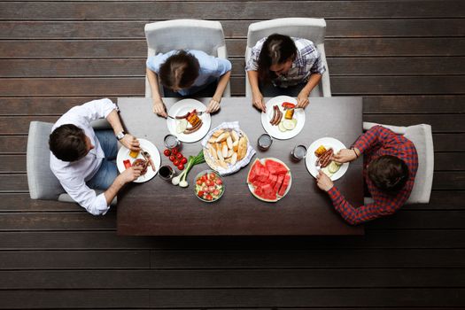 Four friends having dinner, top view