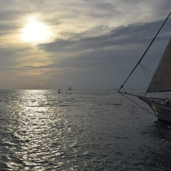 Sailboat on Ocean against Sunset Sky