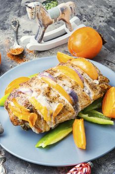 Pork meatloaf baked to the Christmas table.Persimmon baked meat.