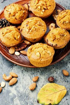 Homemade muffins with nuts on a plate.Nuts muffins
