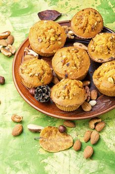 Homemade muffins with nuts on a plate.Nuts muffins
