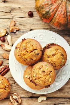 Homemade muffins with nuts on a plate.Nuts muffins