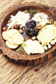 Delicious cheese on the wooden table.Different kinds of cheeses