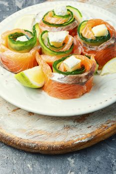 Salmon roll with cheese,cucumber and lime.Rolls of red fish fillet