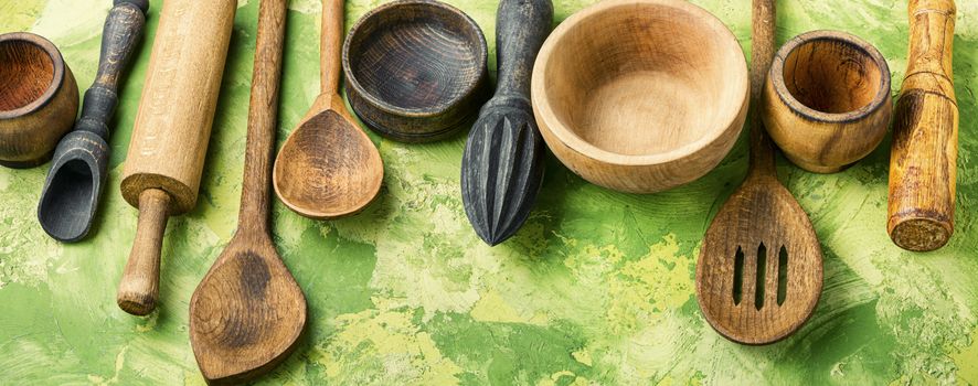 Concept of wooden rustic kitchenware utensils set on old background