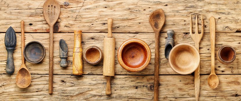 Concept of wooden rustic kitchenware utensils set on old background