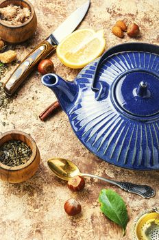 Natural ingredients for tea.Porcelain blue teapot.Useful tea with lemon.Tea concept.