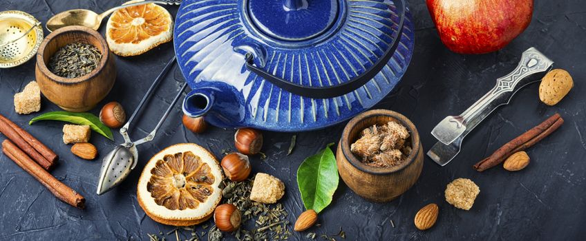 Natural ingredients for tea.Porcelain blue teakettle.Useful tea with lemon.