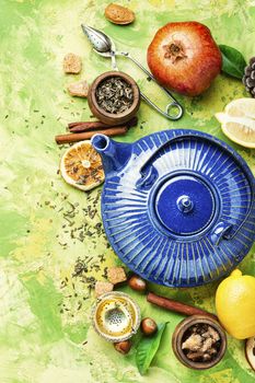 Natural ingredients for tea.Porcelain blue teakettle.Useful tea with lemon.