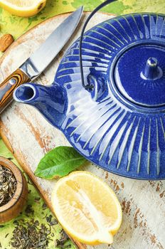Natural ingredients for tea.Porcelain blue teapot.Useful tea with lemon.
