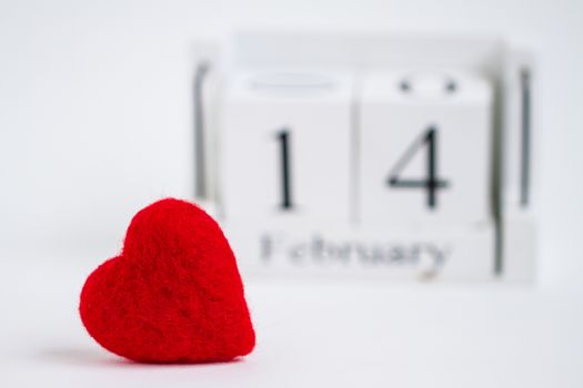 Cube calendar with red heart isolated on white. Valentines day