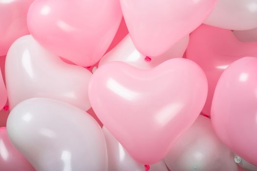 Happy valentines day greetings many heart shaped pink and white balloons background