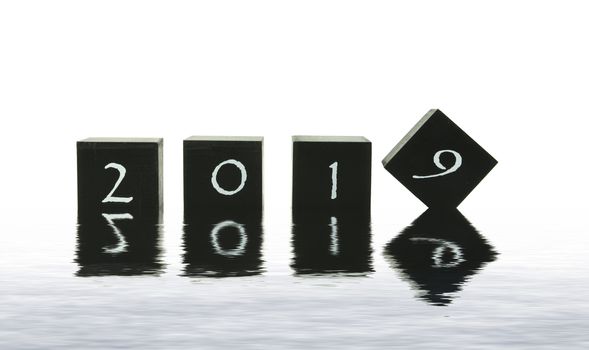 black blocks with 2018 changing in 2019 isolated on white in water reflection