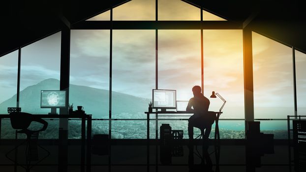 In a modern office with a panoramic window, the silhouette of a web developer at the computer.