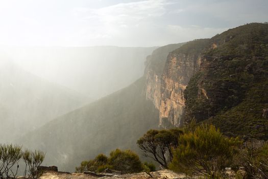 Fierce squally winds and rain falls as sun peeks in and out.  Scenic views of the Grose Valley and its mountain cliff lines.