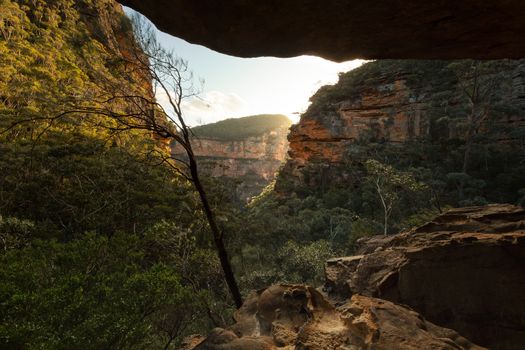 Beautiful sunlight streaming through the mountain gully from a large overhand and cave.  A wonderful place