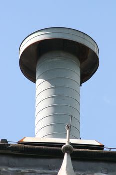 Vent pipe with cover, on top of a building