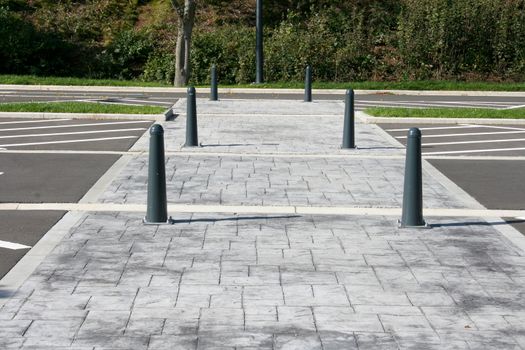 Limited gray paved walkway with iron posts
