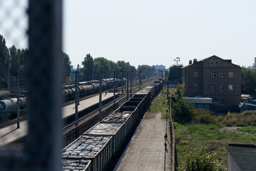 A train with freight cars full of garbage packs.