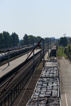 A train with freight cars full of garbage packs.