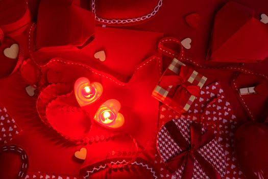 Many valentine day hearts and decor, homemade craft concept, red fabric, paper, gifts and candles