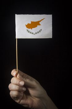 Hand with small flag of state of Cyprus