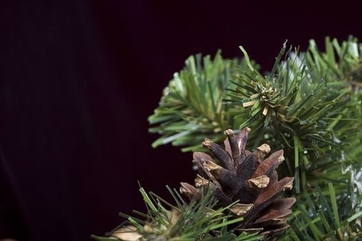 Close-up of artificial pine branch with pine cone