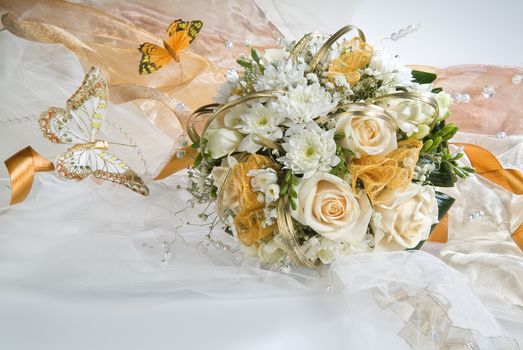 Still life with bouquet of flowers and accessories on a studio background