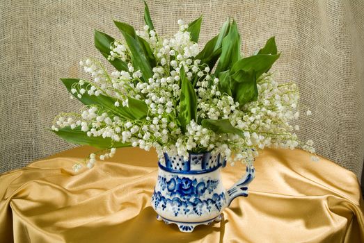 Still life with bouquet of flowers and accessories on a studio background