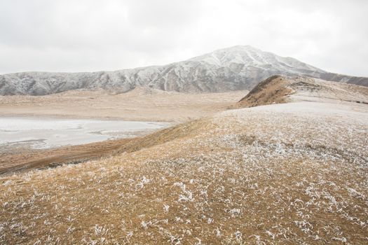 Mount Aso and Kusasenri in winter. covered by golden yellow grassland - Kumamoto, Japan