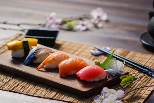 Mix sushi on wood dish, tuna, salmon, sea bass, sweet egg, shrimp sushi, Japanese food