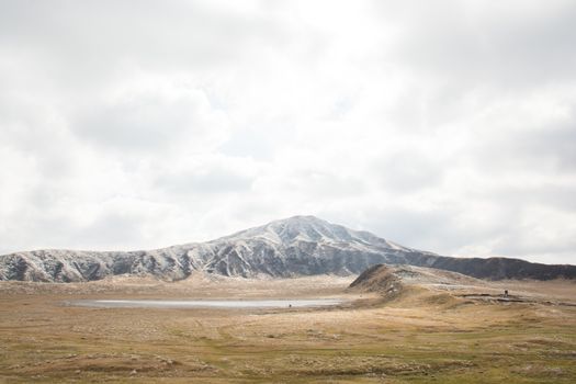 Mount Aso and Kusasenri in winter. covered by golden yellow grassland - Kumamoto, Japan