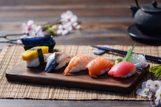 Mix sushi on wood dish, tuna, salmon, sea bass, sweet egg, shrimp sushi, Japanese food