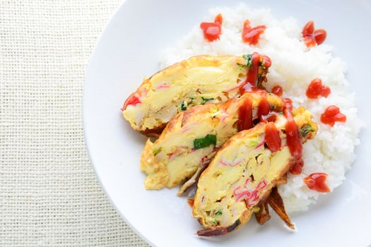 Sliced omelette with soft tofu, crab stick and spring onion with rice on dish