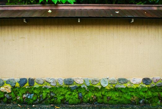 The plain wall with the stones.