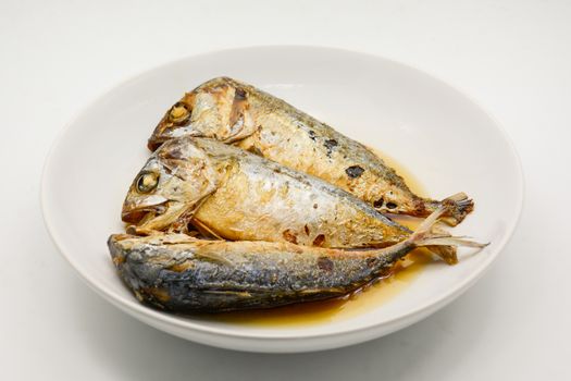 Fried mackerel on white plate. Deep fried fish