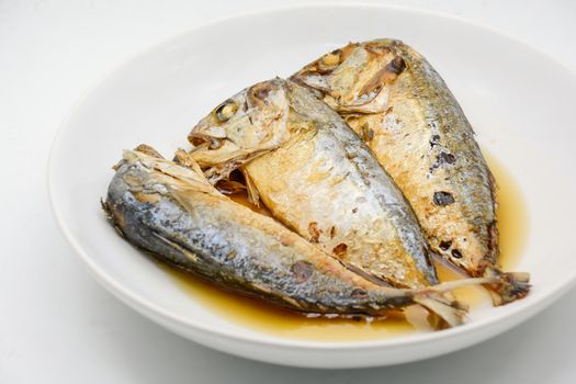 Fried mackerel on white plate. Deep fried fish